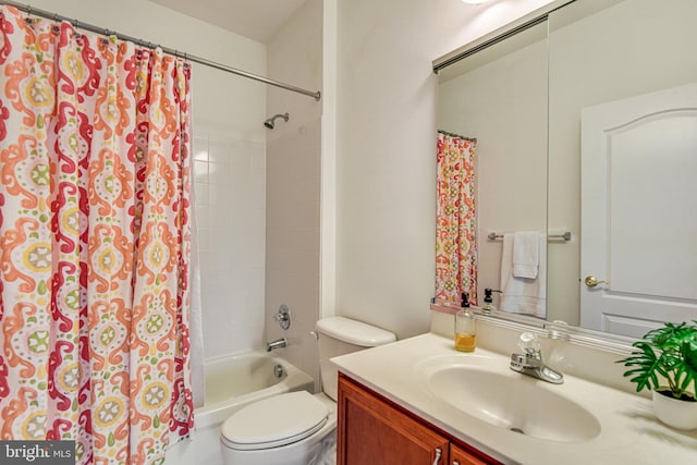 full bath featuring toilet, vanity, and shower / tub combo