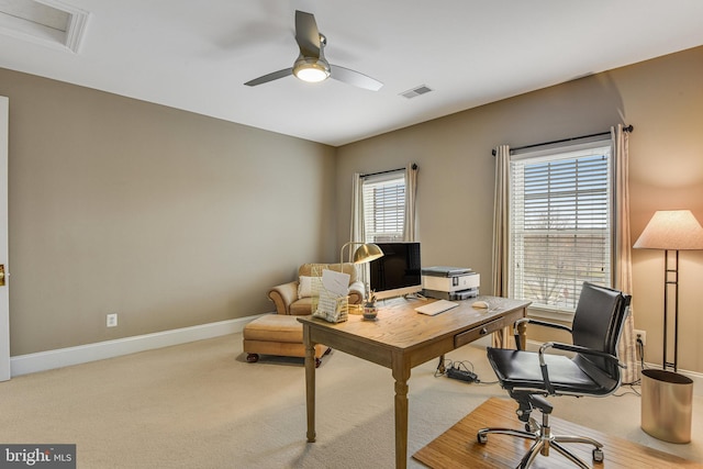 carpeted office featuring a ceiling fan, baseboards, and visible vents