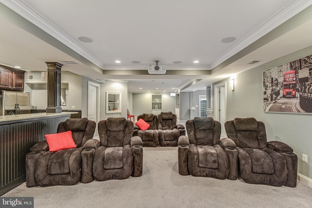 carpeted home theater room with visible vents, crown molding, a tray ceiling, decorative columns, and recessed lighting