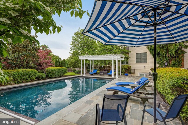 pool with a patio, fence, and a pergola