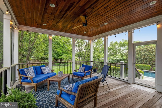 sunroom with wood ceiling and a ceiling fan