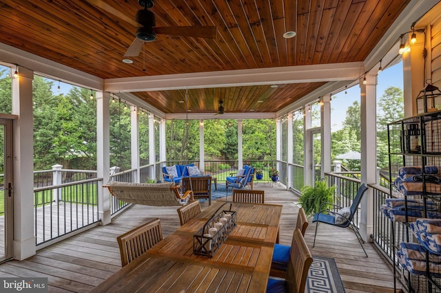 deck featuring ceiling fan and outdoor lounge area