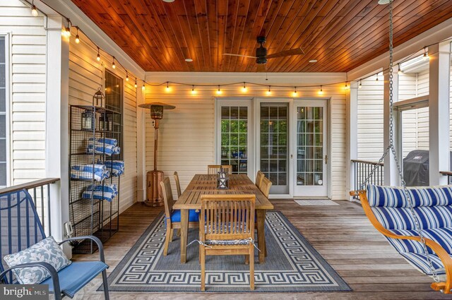 sunroom featuring wood ceiling and ceiling fan