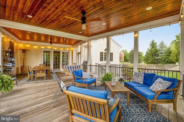 sunroom with wood ceiling and ceiling fan