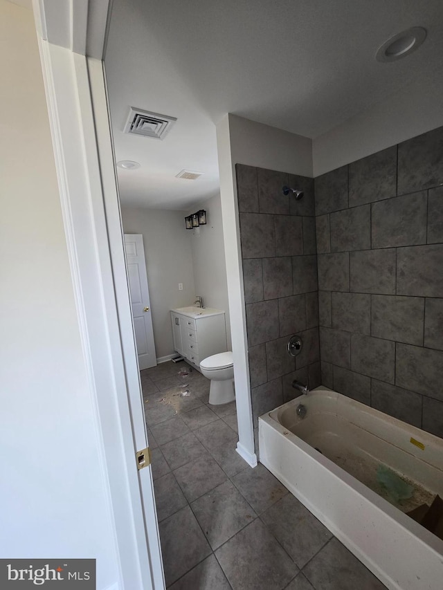 full bath featuring visible vents, bathing tub / shower combination, toilet, tile patterned flooring, and vanity