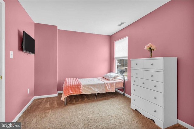 bedroom featuring visible vents, baseboards, and carpet