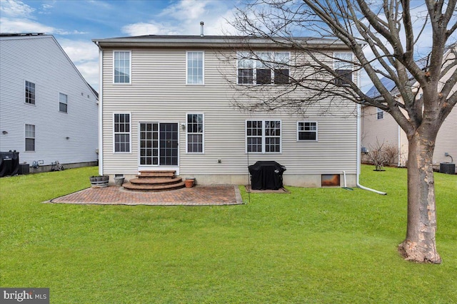 rear view of house featuring entry steps, a patio area, central AC unit, and a lawn