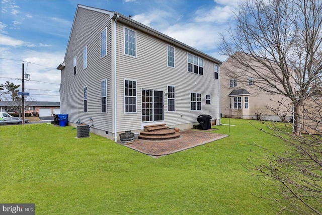 back of house featuring entry steps, a patio area, a yard, and cooling unit