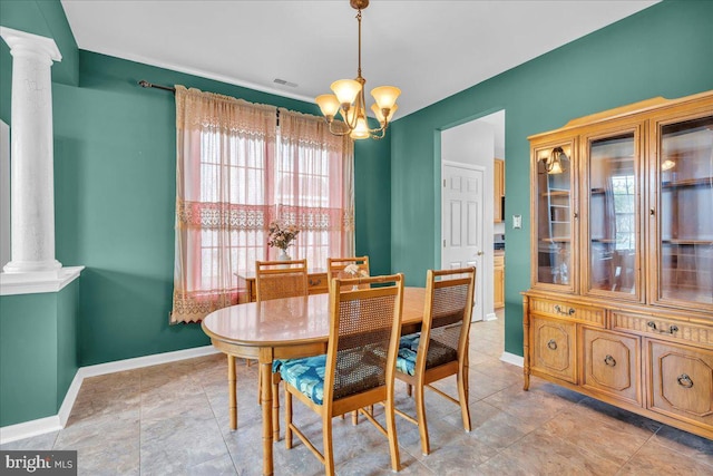 dining space with decorative columns, baseboards, a notable chandelier, and visible vents