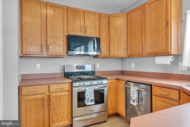 kitchen with appliances with stainless steel finishes and light countertops