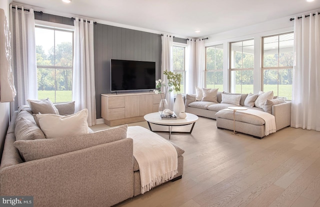 living area featuring recessed lighting, plenty of natural light, and light wood-style floors