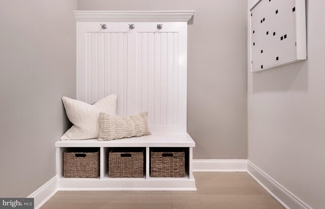 mudroom featuring wood finished floors and baseboards