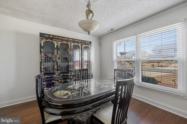 dining area featuring dark wood-style flooring, visible vents, and crown molding