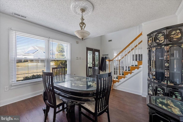 dining room with crown molding, stairs, visible vents, and wood finished floors