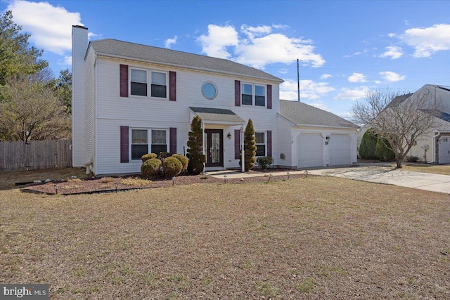 view of front of property with a front lawn, concrete driveway, fence, and an attached garage