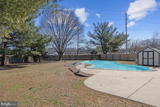 view of swimming pool featuring a fenced in pool, an outbuilding, a patio, a shed, and a fenced backyard