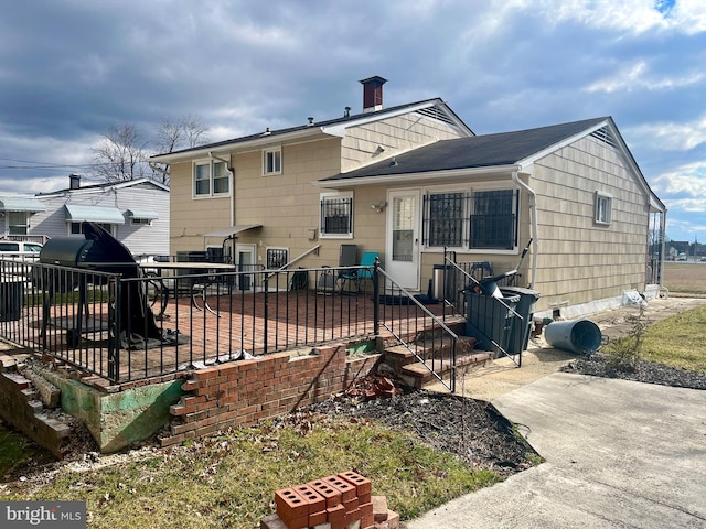 back of house with crawl space and a patio