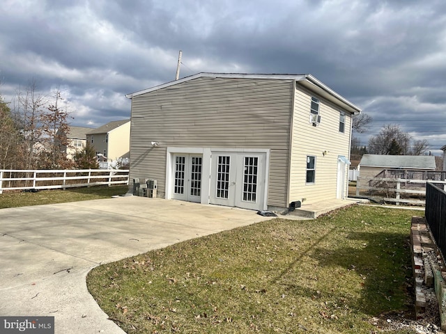 back of house with french doors, fence, a yard, and a patio area