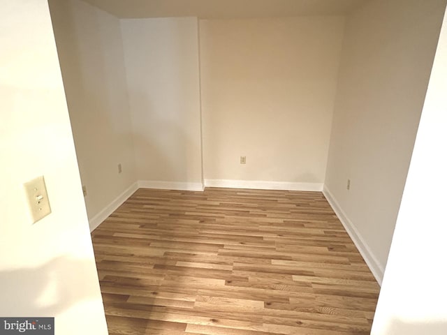 unfurnished room featuring light wood-style flooring and baseboards