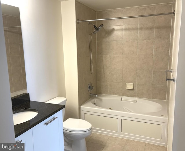 bathroom featuring tile patterned flooring, toilet, vanity, and washtub / shower combination