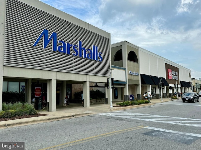 view of building exterior with uncovered parking