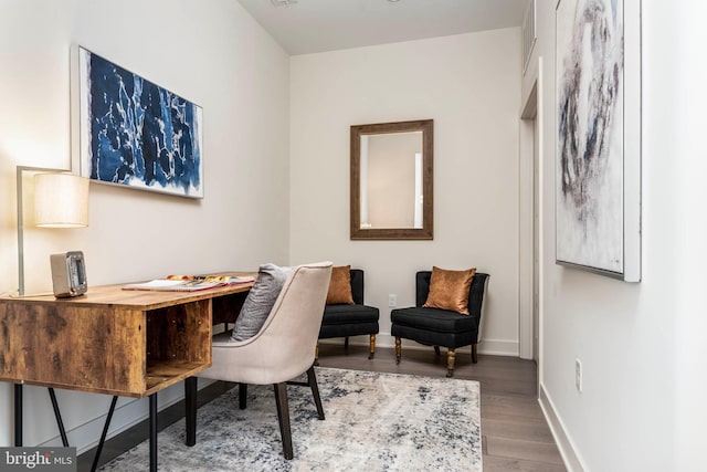 home office featuring baseboards and wood finished floors