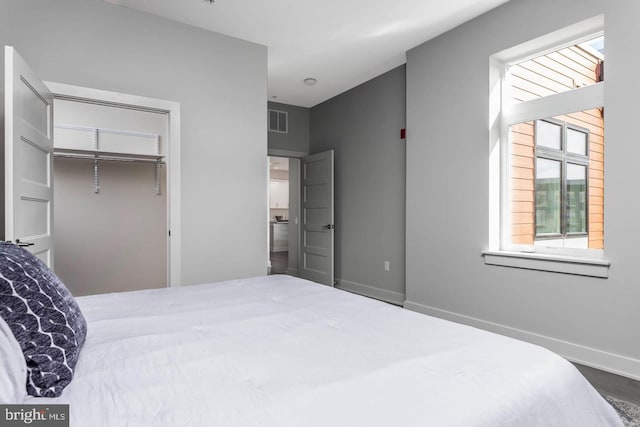 bedroom with visible vents, baseboards, and a closet