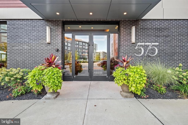 doorway to property featuring french doors and brick siding