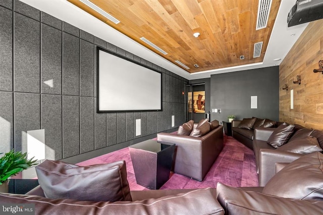 cinema room with visible vents, wooden ceiling, and a raised ceiling