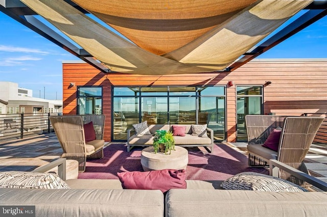 view of patio with outdoor lounge area and a balcony