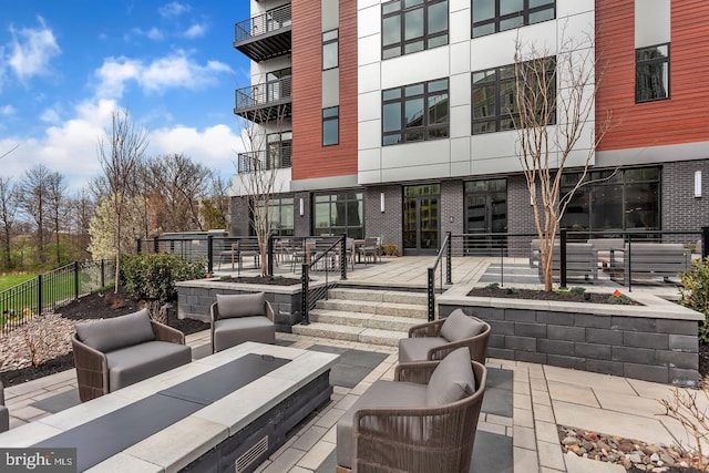 575 S Goddard Blvd Unit 210, King Of Prussia, PA 19406 - view of patio featuring fence and an outdoor living space with a fire pit