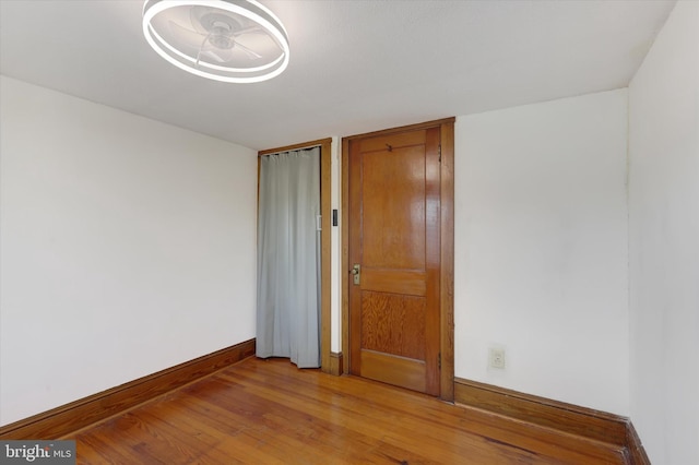 empty room with baseboards and light wood-style floors