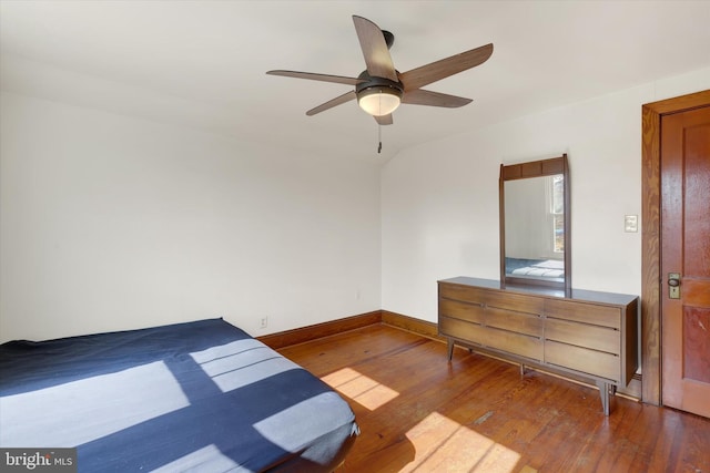 bedroom featuring ceiling fan, baseboards, and wood-type flooring