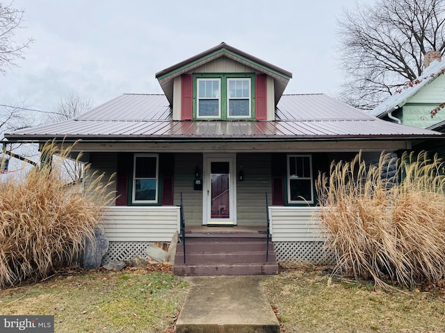 view of front of home featuring metal roof and a porch