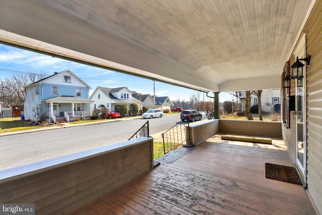 deck with a porch and a residential view