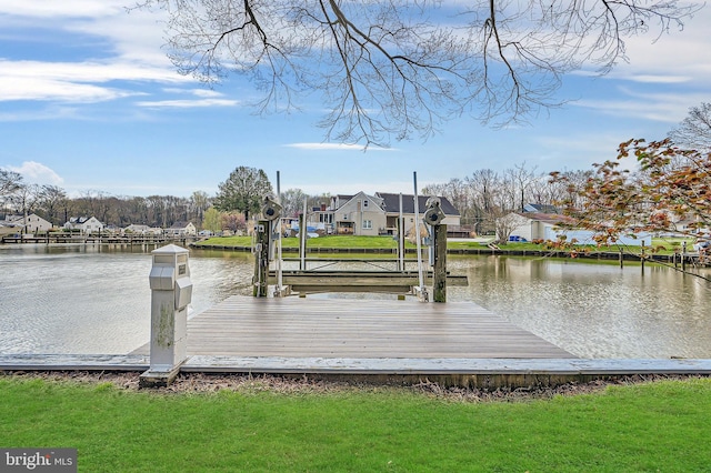 dock area featuring a residential view, a water view, and a lawn