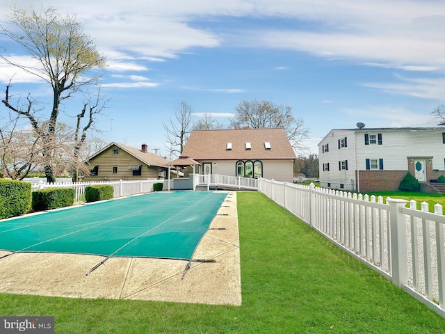 view of swimming pool featuring a patio, a lawn, a fenced backyard, and a fenced in pool