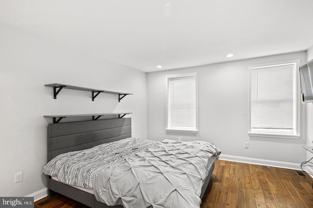 bedroom featuring wood-type flooring, baseboards, and recessed lighting