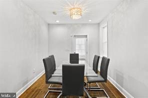 dining area featuring baseboards, dark wood finished floors, and recessed lighting