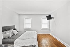 bedroom with wood finished floors and baseboards