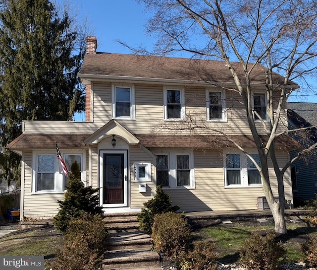 view of front of home featuring a chimney