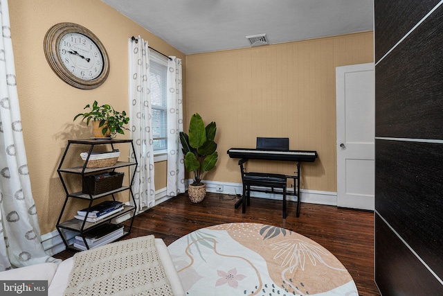 sitting room with visible vents, baseboards, and wood finished floors