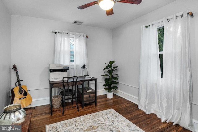 office with visible vents, a ceiling fan, baseboards, and wood finished floors