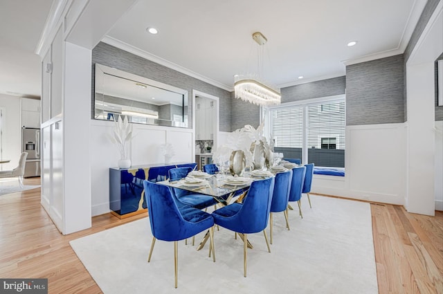 dining area featuring light wood-style flooring, recessed lighting, a wainscoted wall, and ornamental molding