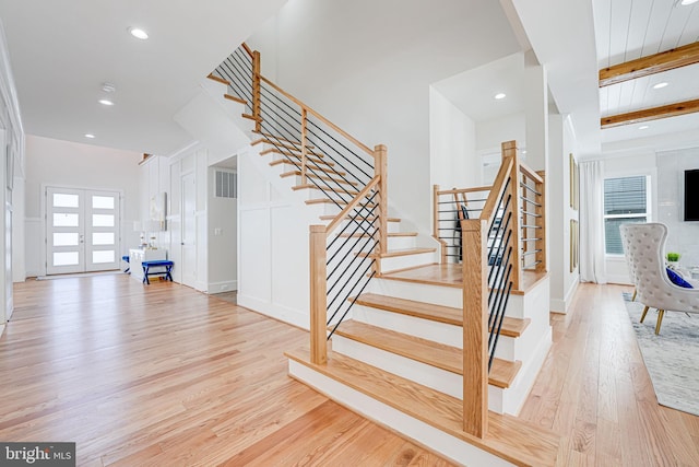 staircase featuring visible vents, beam ceiling, recessed lighting, french doors, and wood finished floors