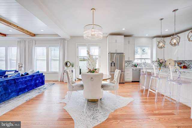 dining space with recessed lighting, a chandelier, beam ceiling, and light wood-style flooring