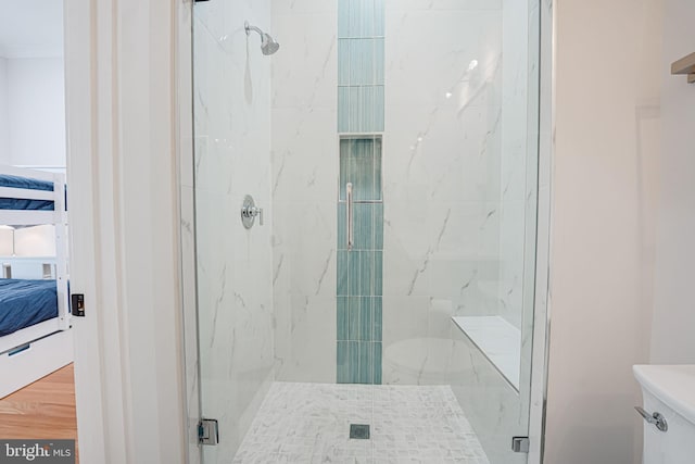 full bathroom with a marble finish shower and ensuite bathroom