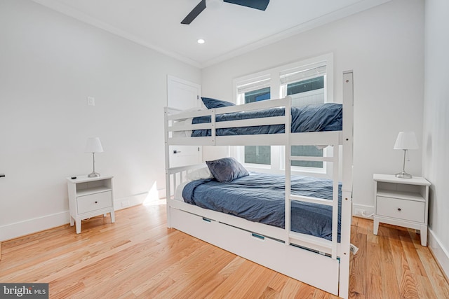 bedroom featuring recessed lighting, baseboards, wood finished floors, and ornamental molding