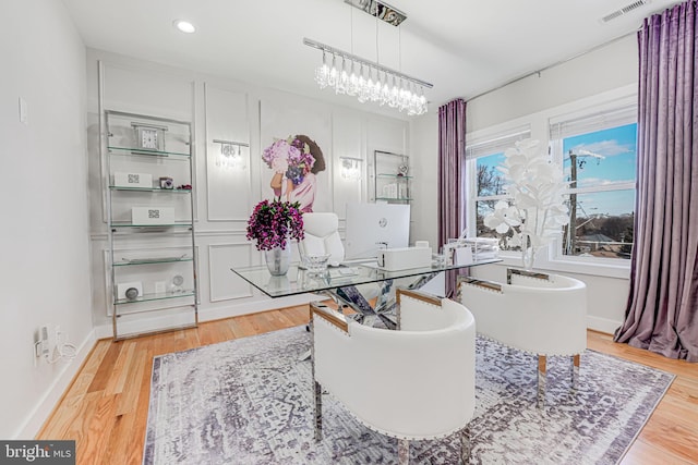 office area with visible vents, baseboards, recessed lighting, light wood-style floors, and a notable chandelier