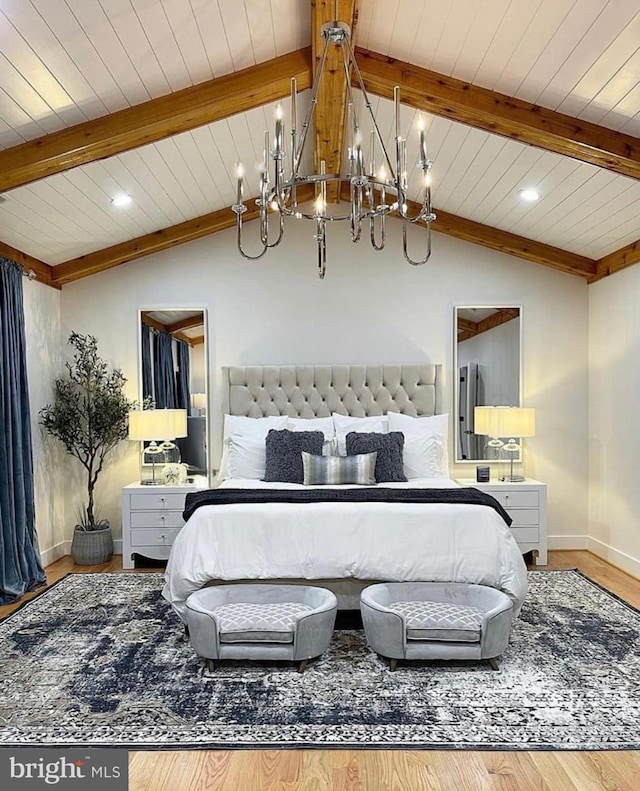 bedroom with lofted ceiling with beams, a chandelier, baseboards, and wood finished floors